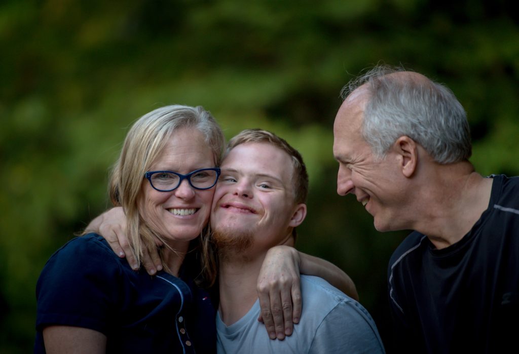young man with intellectual disability and parents