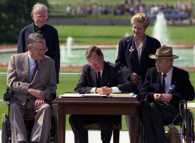 President Bush signs the Americans with Disabilities Act on the South Lawn of the White House